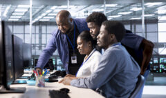 Group of technicians doing brainstorming, reconfiguring server farm